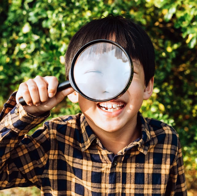 young boy holding microscope up to eye young boy holding microscope up to eye